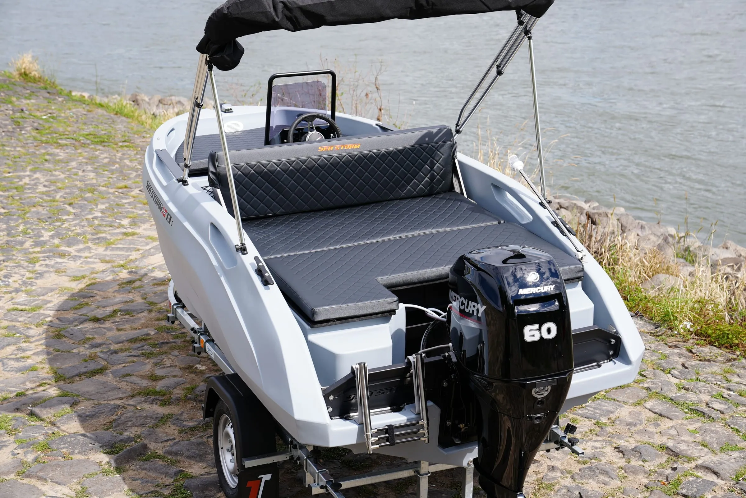 Stern of the SeaStorm 13s with Mercury F60 and sun lounger
