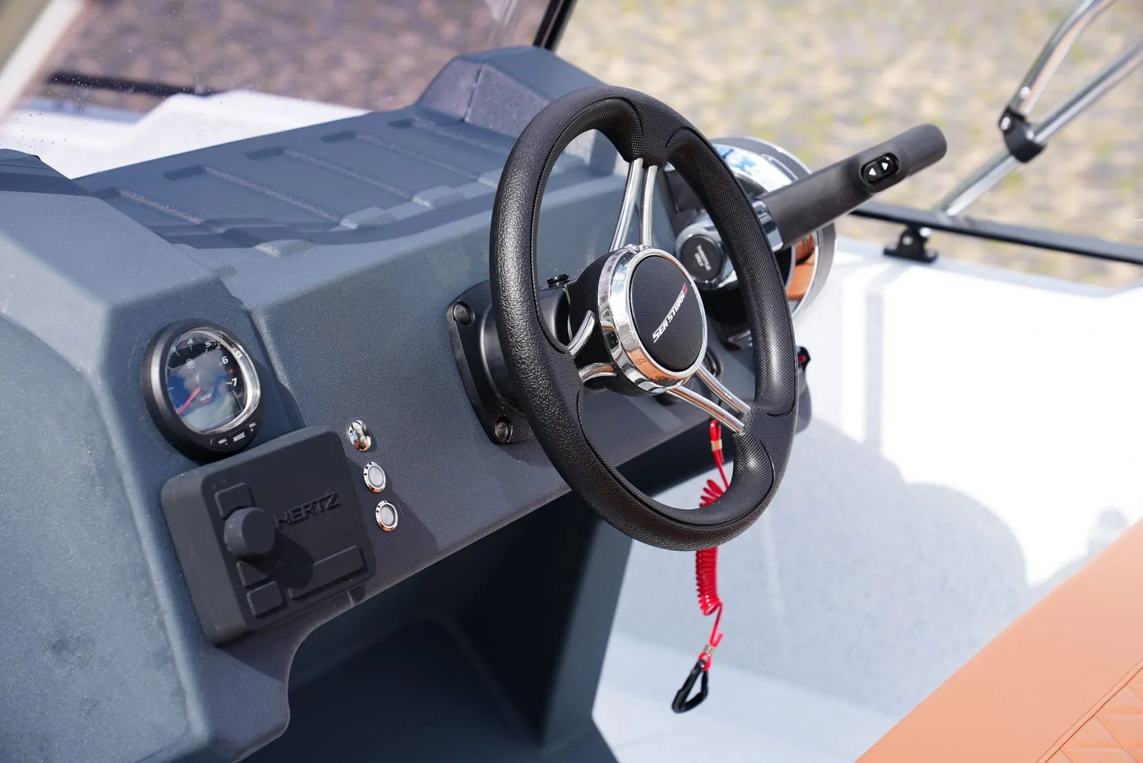 Console of the SeaStorm 17 with sports steering wheel and gauges