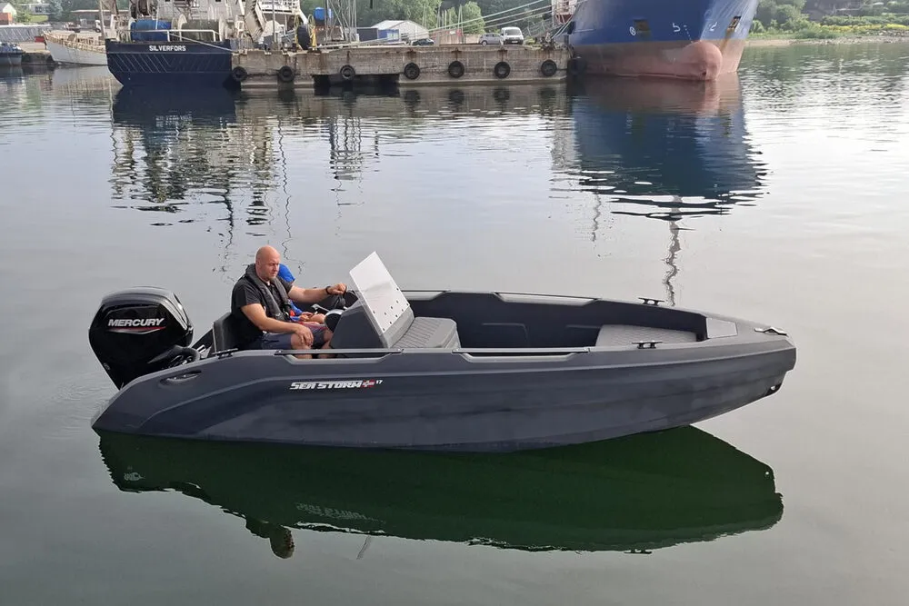 Sports boat with HDPE hull underway on water, wake visible at stern